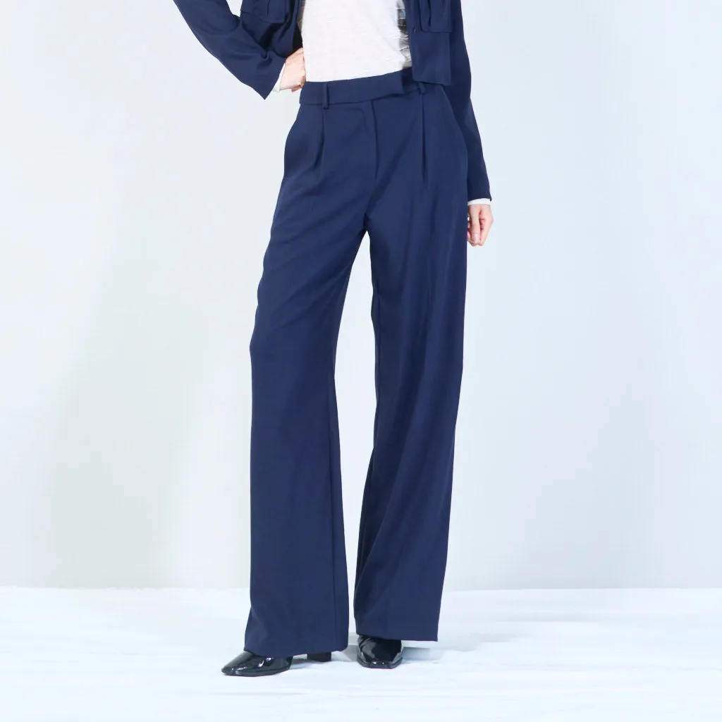 High-waisted trousers with pleated front and button detail wholesale